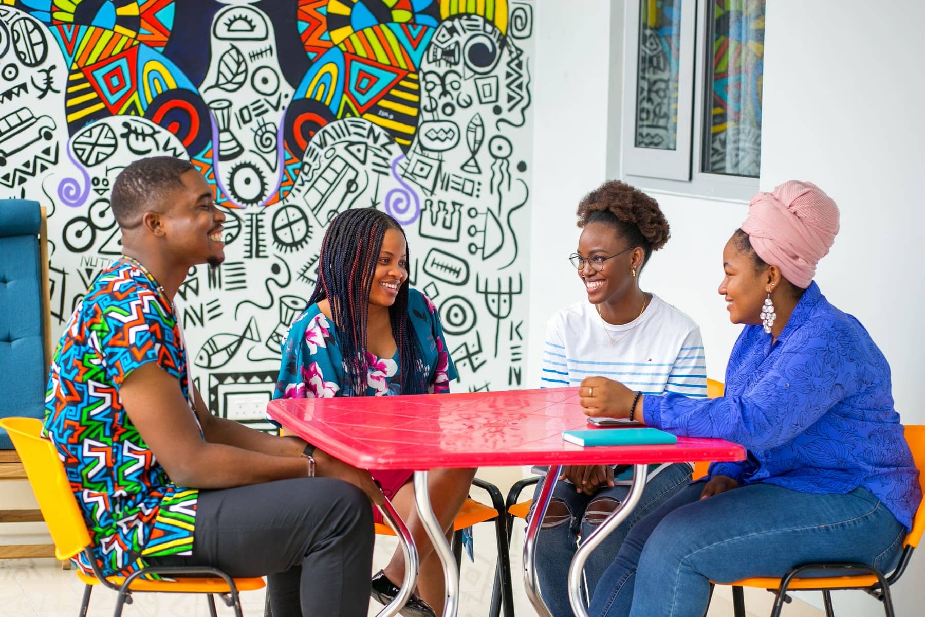 Students talking around a table in the common room